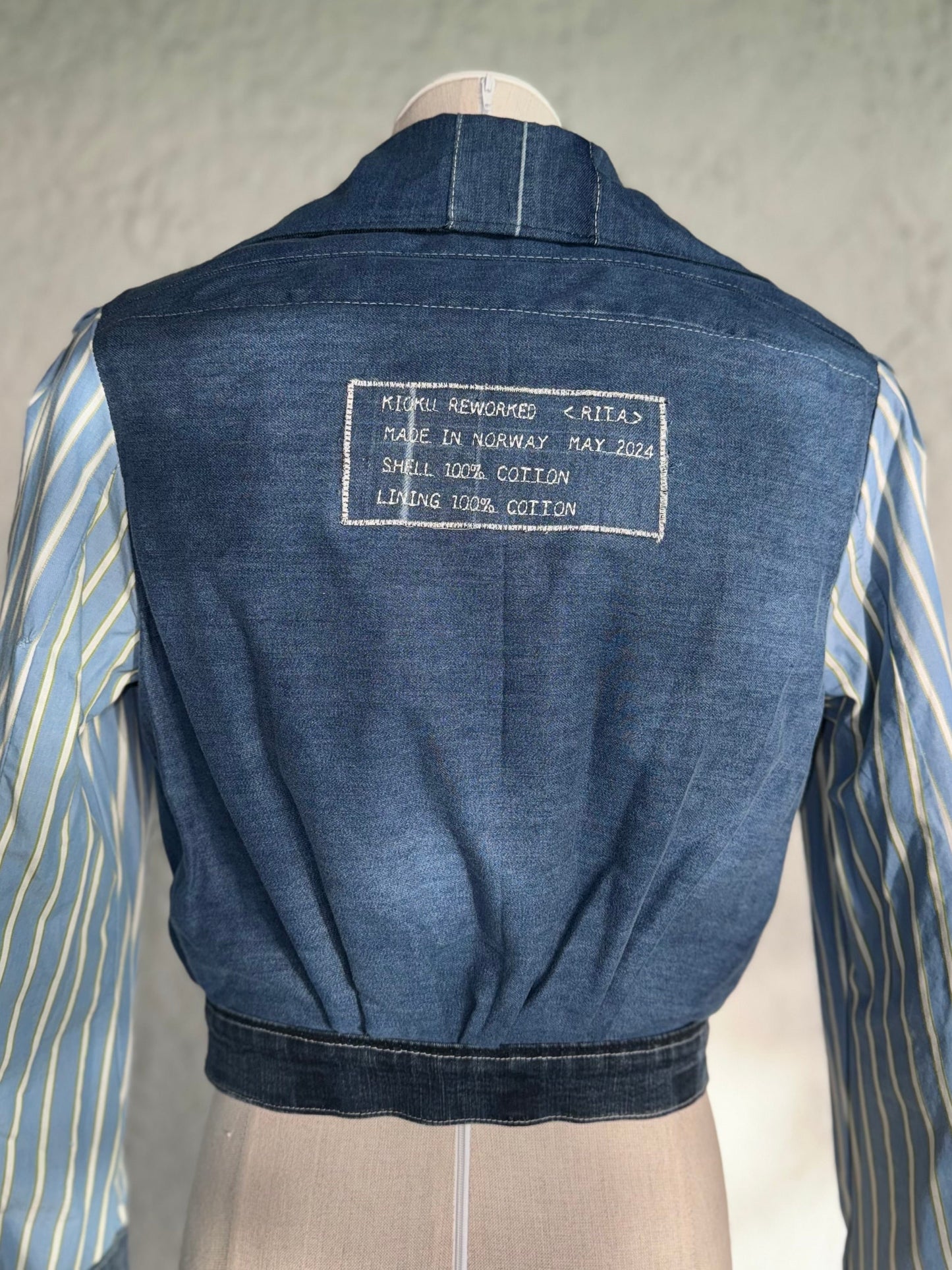 dark blue reversible cropped denim jacket by KIOKU Studio reversed side close up