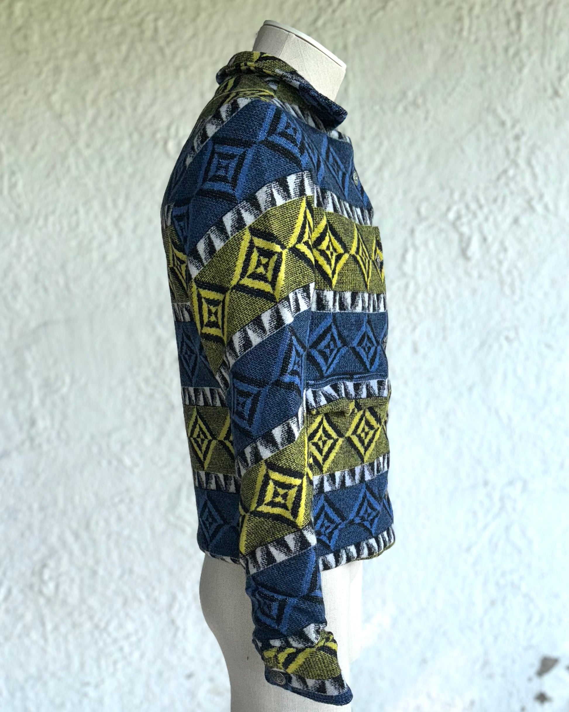 side view of the blue and yellow one of a kind short jacket, boxy fit with two square pockets, silver tone metal buttons