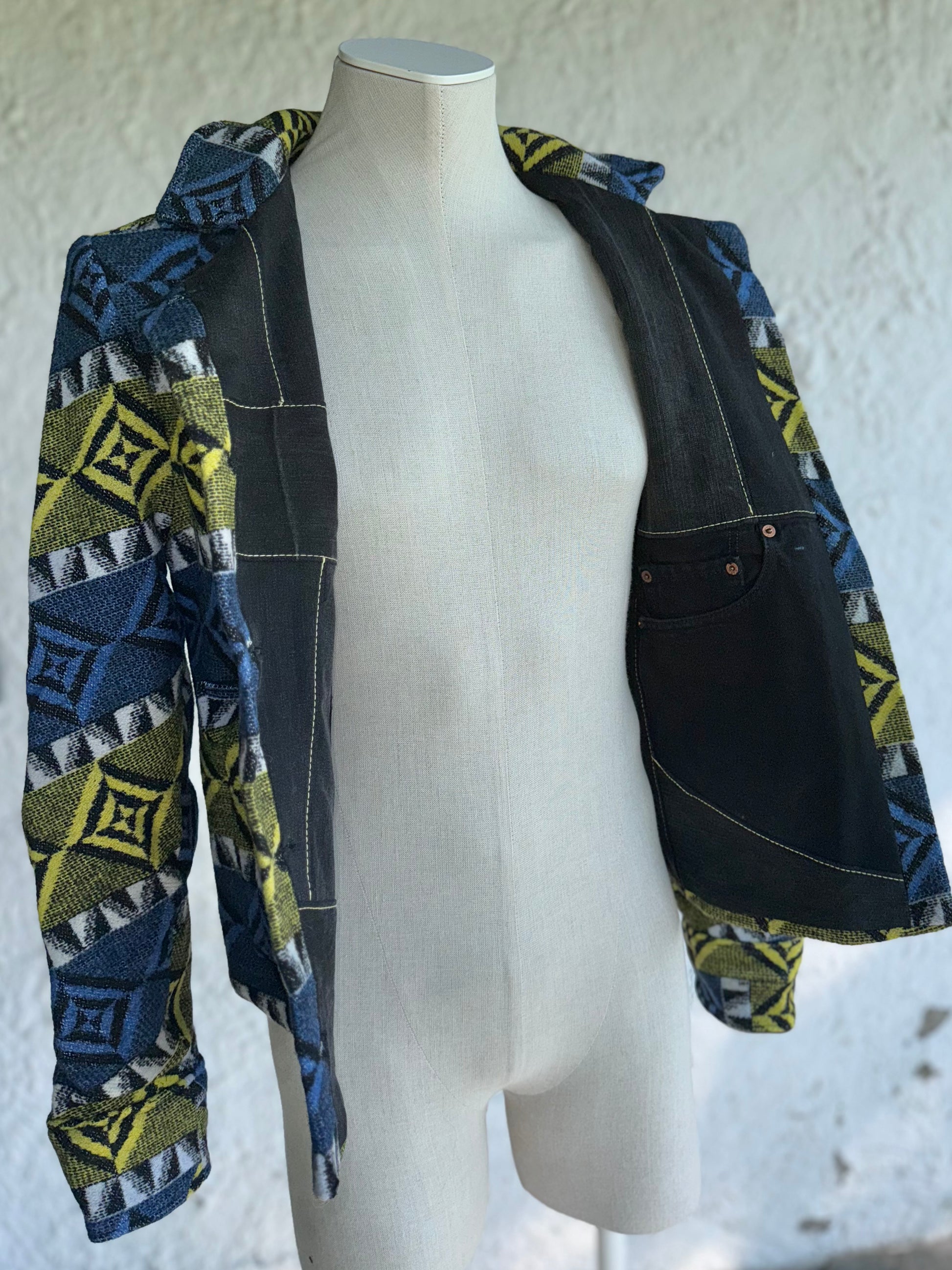 open front revealing denim lining with inside pockets of the blue and yellow one of a kind short jacket