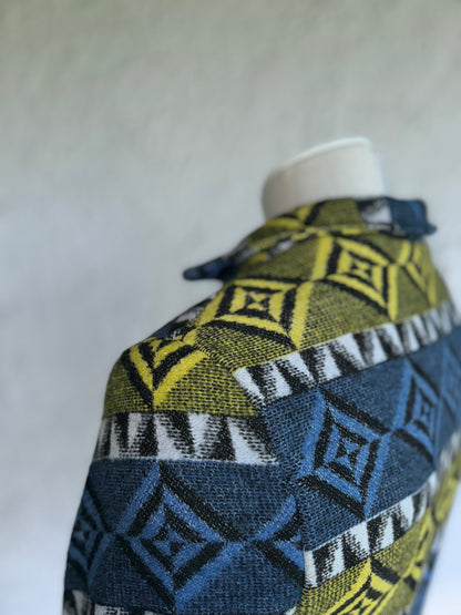 close up of the shoulder stitching and fabric texture of the blue and blue yellow one of a kind short jacket